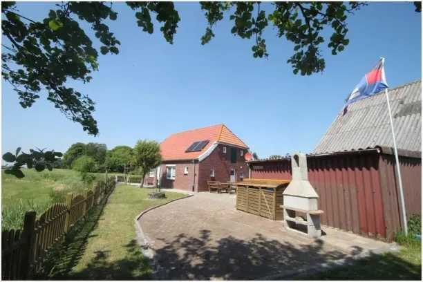 BookNoFees: Tranquila casa de vacaciones de ladrillo con jardín cercado – Dornum