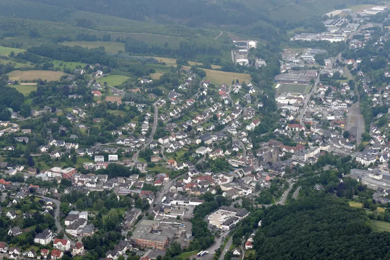 La ciudad de Sundern vista desde el aire, con casas a lo largo del valle del Röhr entre colinas boscosas